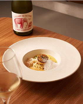 Seared scallop with pearl pasta served alongside Elephant in the Room Chardonnay.